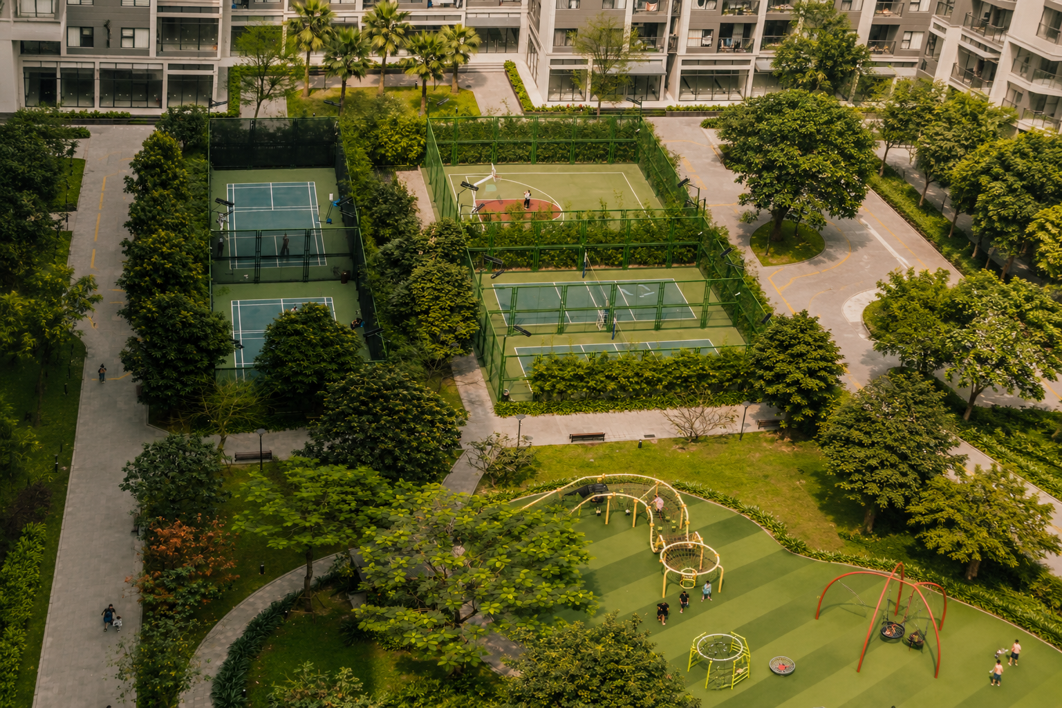 Aerial view of community amenities including courts, green space, and a playground